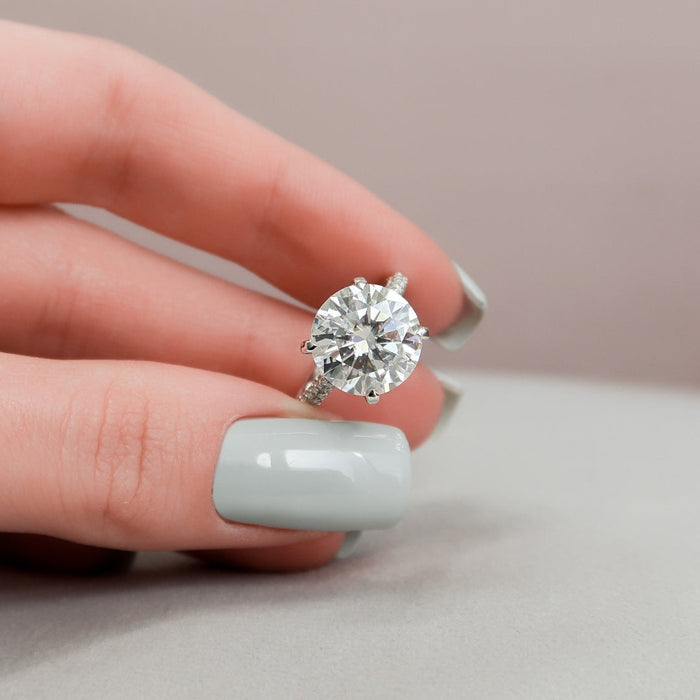 Large round brilliant lab grown diamond engagement ring worn on the hand