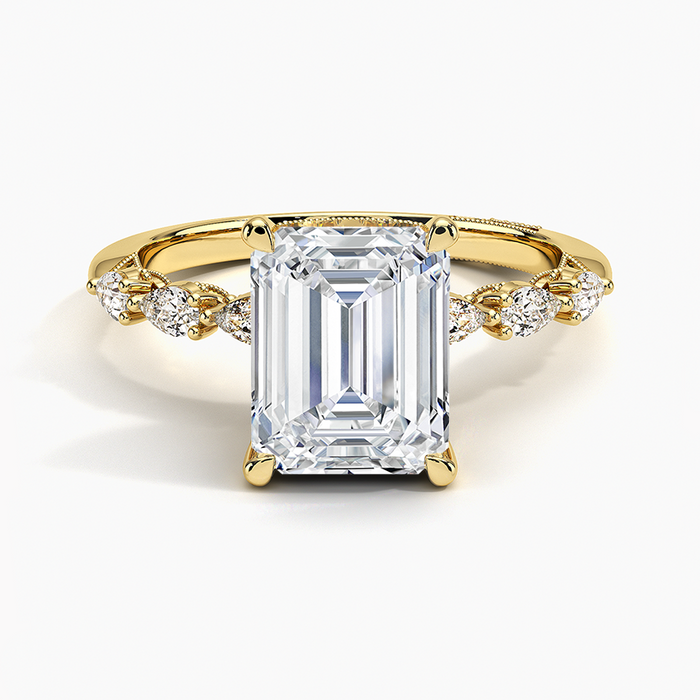 Emerald cut lab grown diamond ring in yellow gold with milgrain accent panels along the band, top view