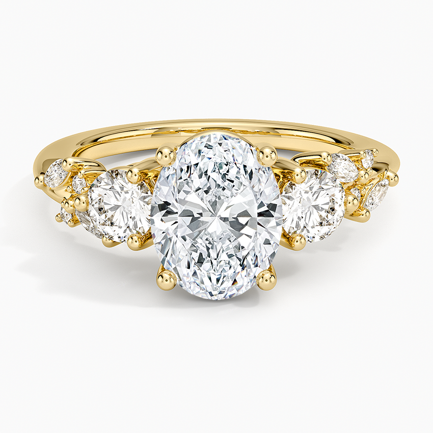 Oval cut lab grown diamond three stone ring with scattered marquise accents in yellow gold, top view