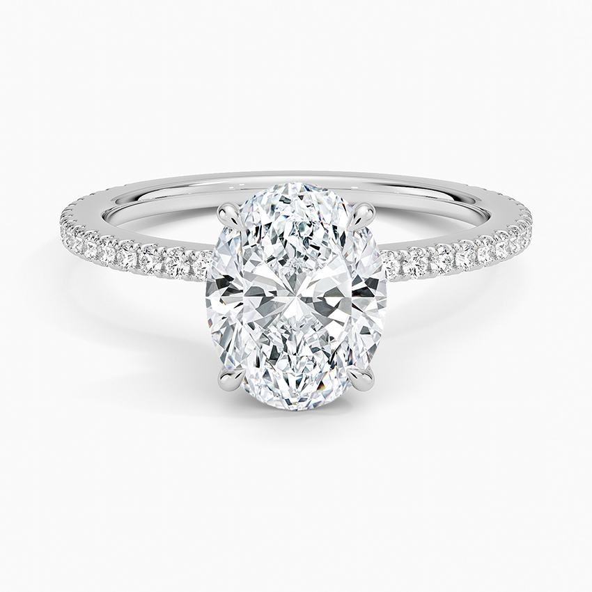Oval cut lab grown diamond ring on a three quarter pave white gold band, top view
