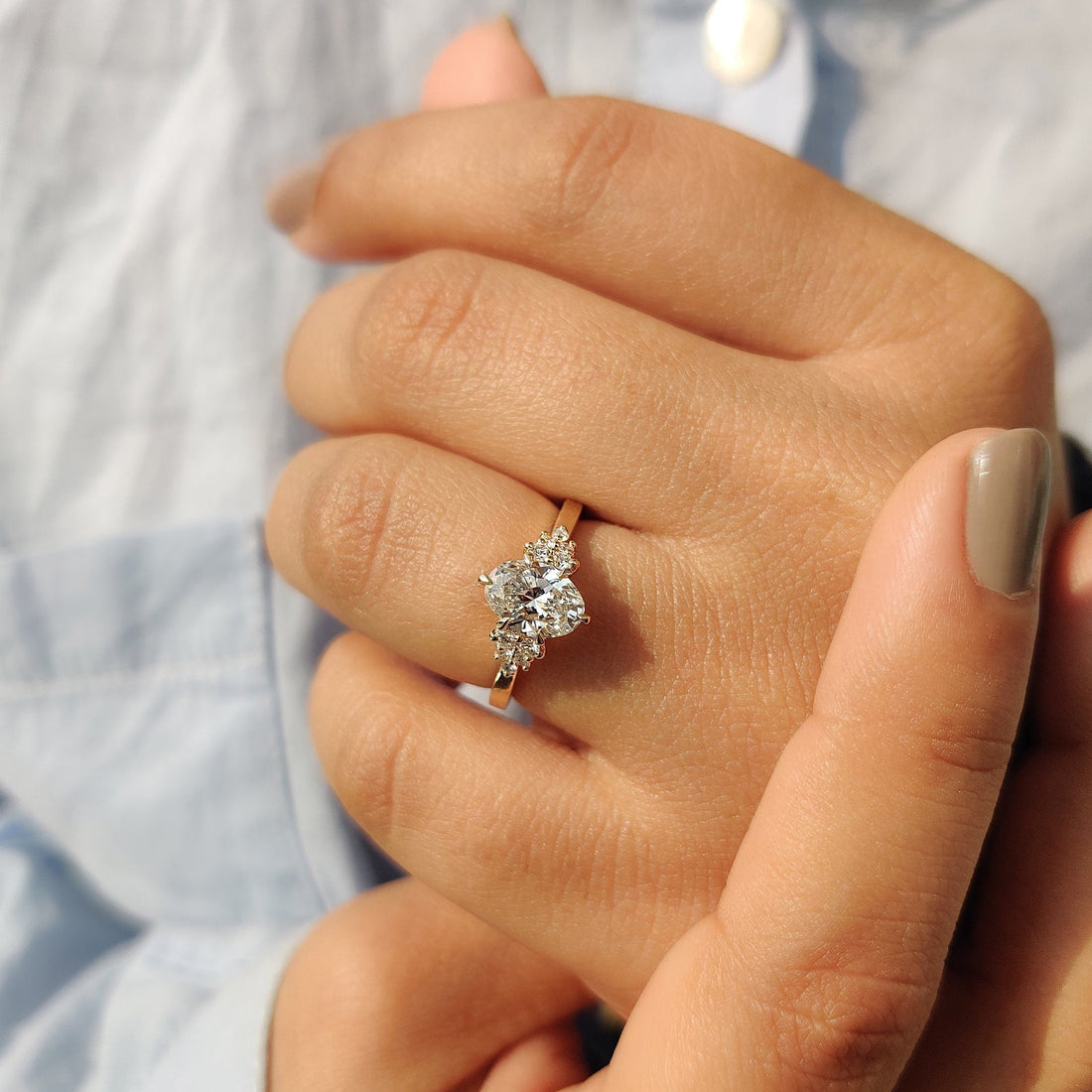 Oval cut lab grown diamond side cluster ring worn on the hand
