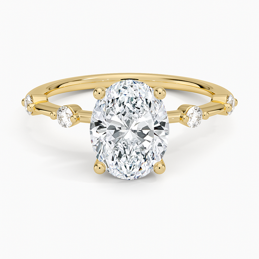 Oval cut lab grown diamond ring with alternating large and small spaced accents in yellow gold, top view