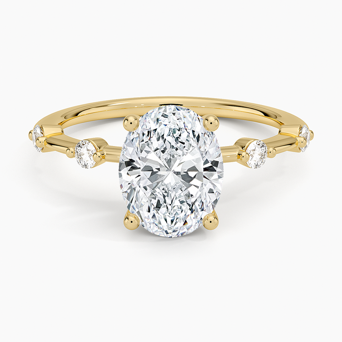 Oval cut lab grown diamond ring with alternating large and small spaced accents in yellow gold, top view