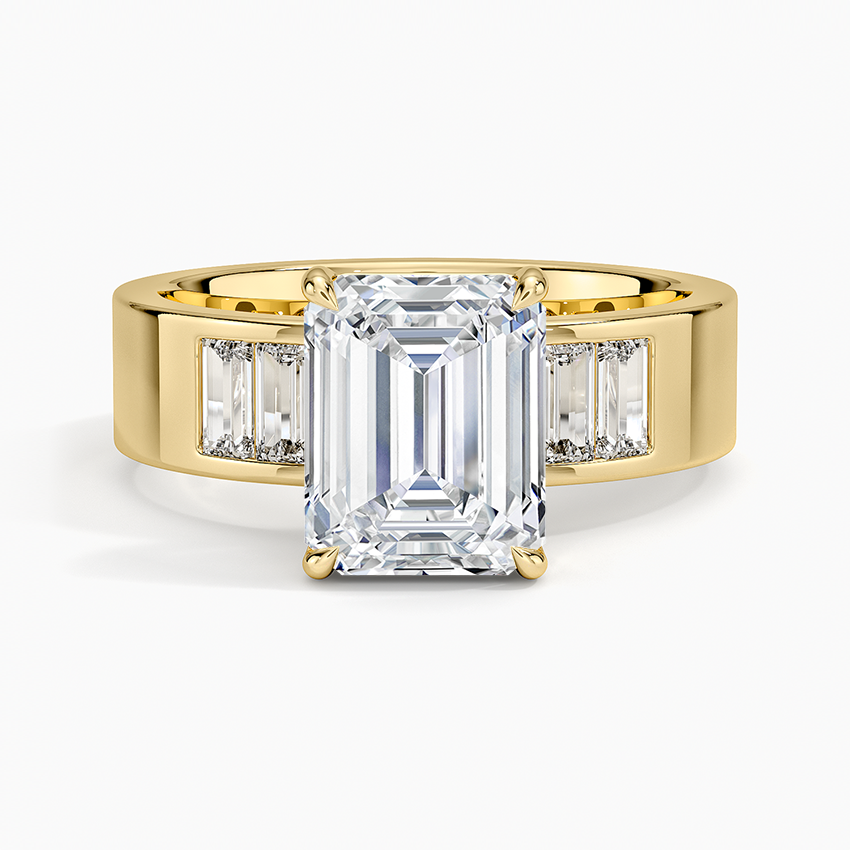 Emerald cut lab grown diamond ring on a wide flat yellow gold band with flush baguettes, top view
