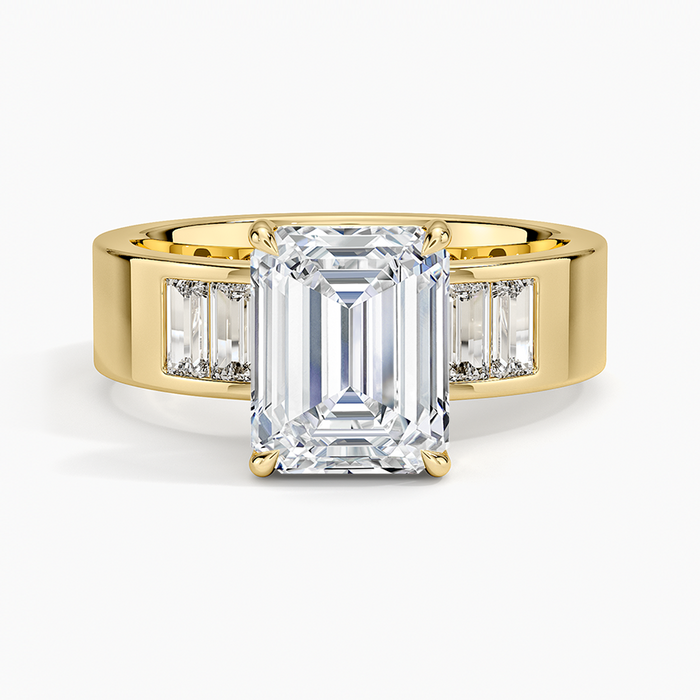 Emerald cut lab grown diamond ring on a wide flat yellow gold band with flush baguettes, top view