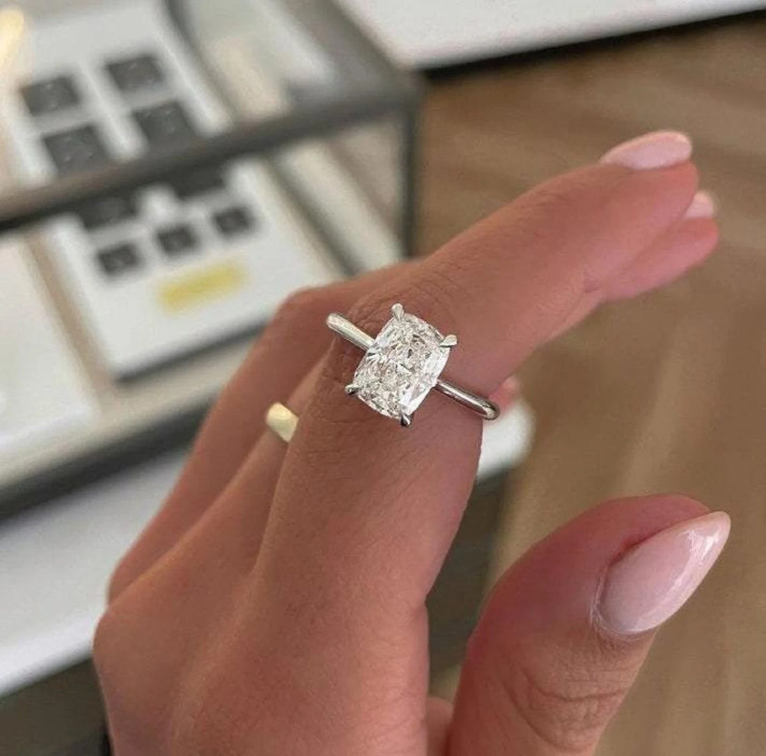 Elongated cushion cut lab grown diamond solitaire engagement ring on a plain band