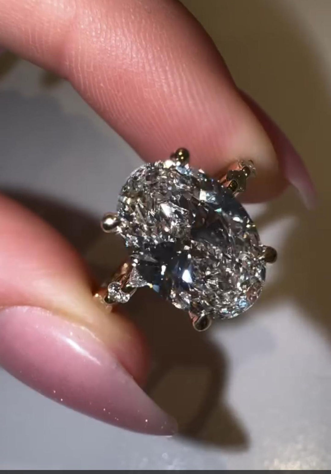 Oval cut lab grown diamond hidden halo engagement ring with marquise and round accent band in yellow gold