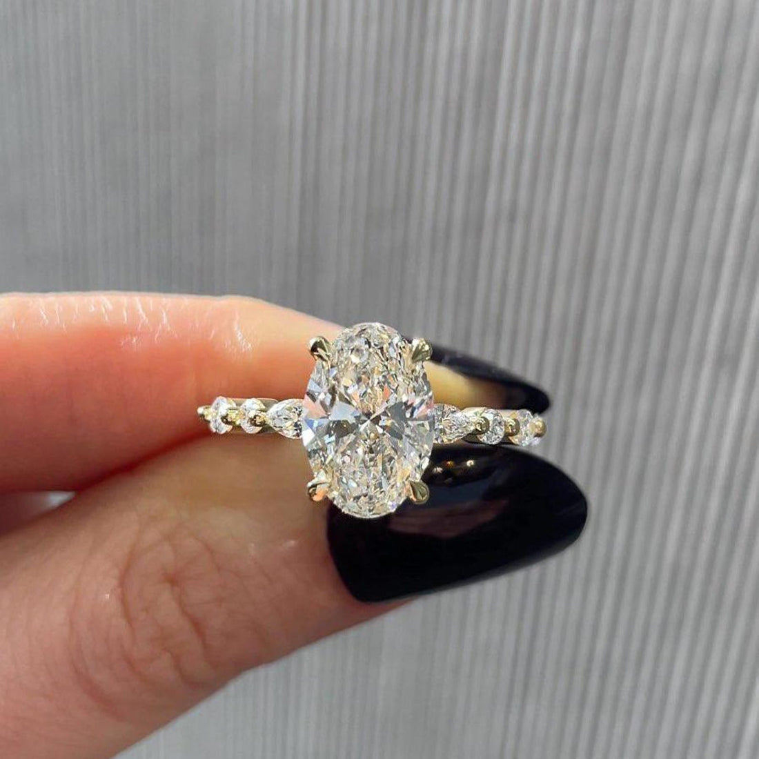 Oval cut lab grown diamond engagement ring with alternating marquise and round diamond band in yellow gold, top view