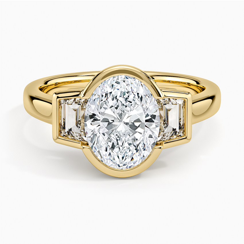 Oval cut lab grown diamond bezel set with trapezoid side stones in yellow gold, top view