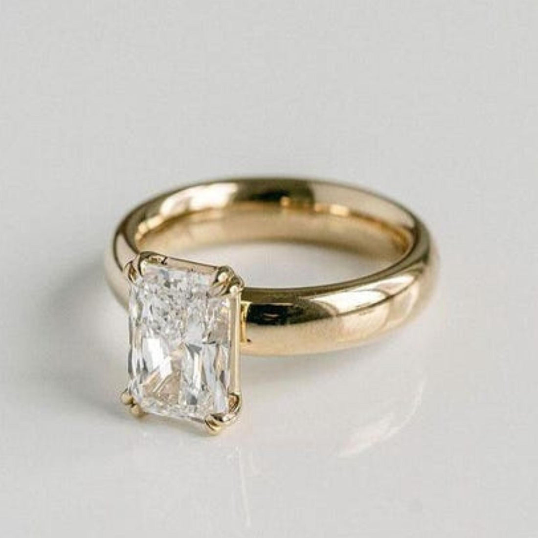 Radiant cut lab grown diamond double prong solitaire engagement ring in yellow gold