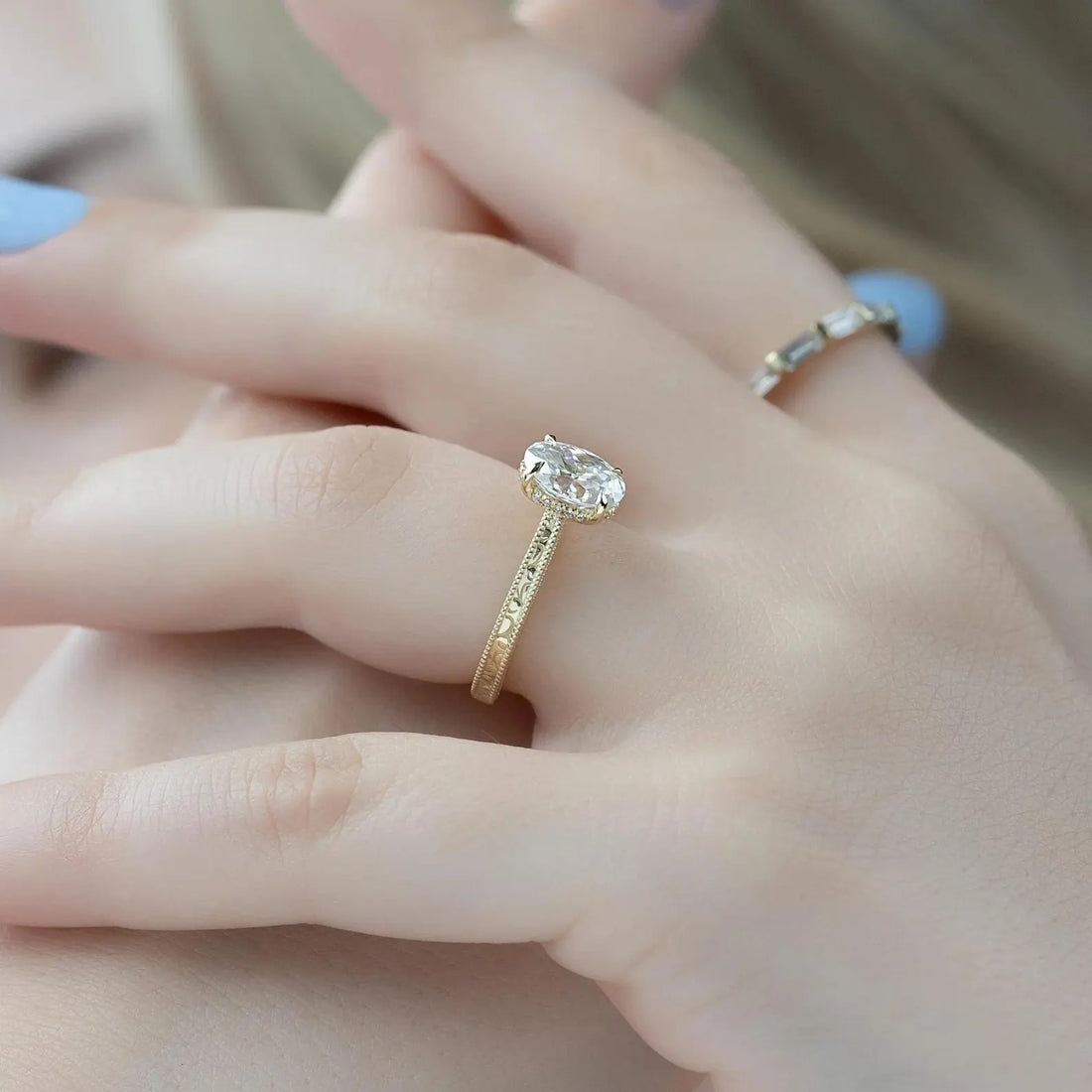 Oval cut lab grown diamond engagement ring with hidden halo in yellow gold