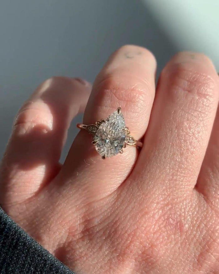 Pear cut lab grown diamond engagement ring with pave band in rose gold