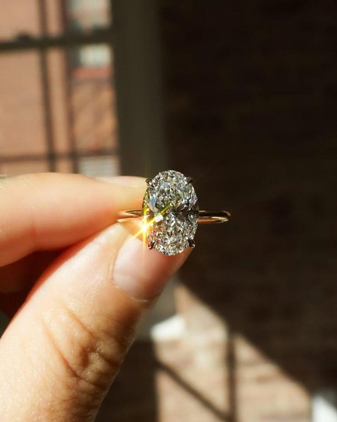 Oval cut lab grown diamond hidden halo solitaire ring in yellow gold