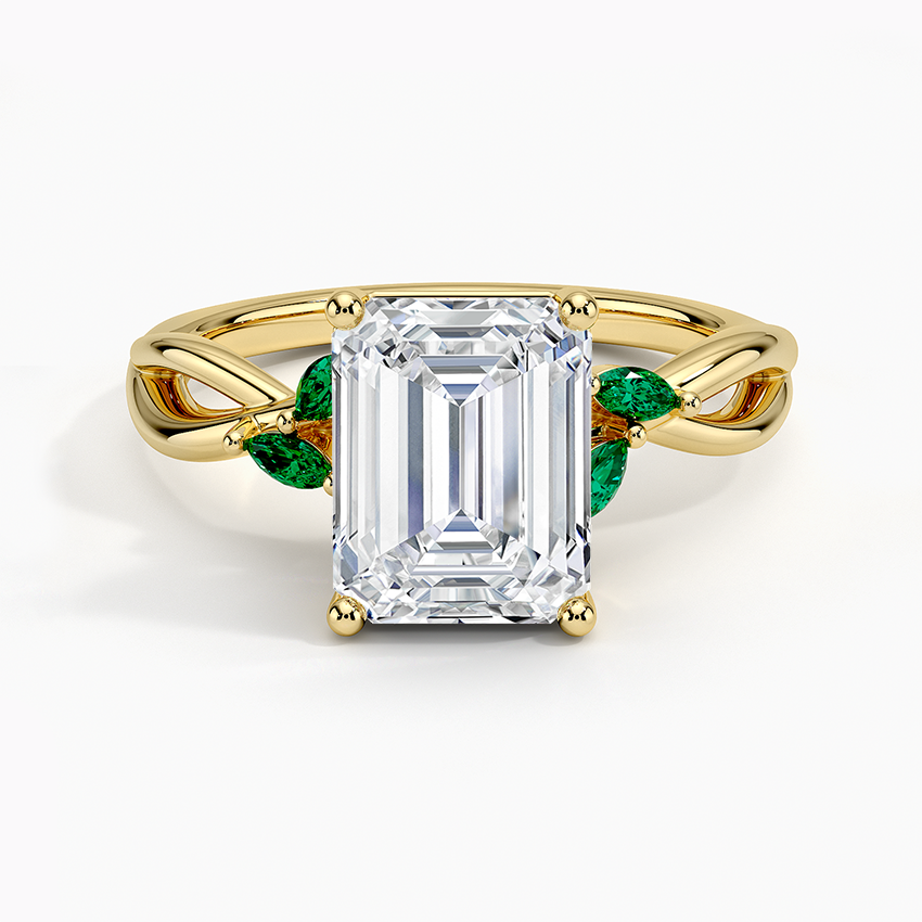Emerald cut lab grown diamond ring in yellow gold with four marquise green emerald leaves, top view