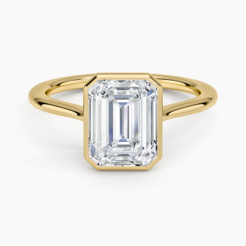 Emerald cut lab grown diamond ring in yellow gold with full bezel and split wire band, top view