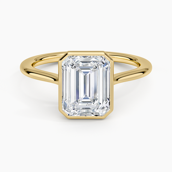 Emerald cut lab grown diamond ring in yellow gold with full bezel and split wire band, top view