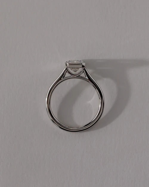 Bezel set emerald cut diamond solitaire engagement ring