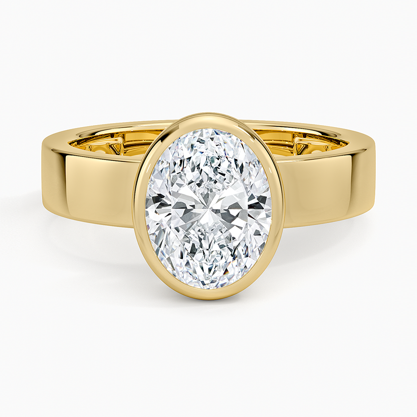 Oval cut lab grown diamond in a full bezel on a wide flat yellow gold band, top view