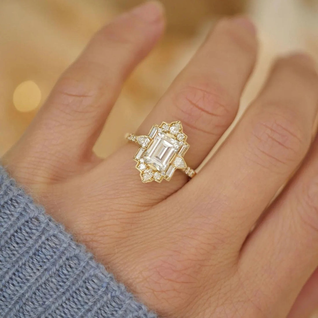 Vintage emerald cut lab grown diamond engagement ring with fan halo in yellow gold