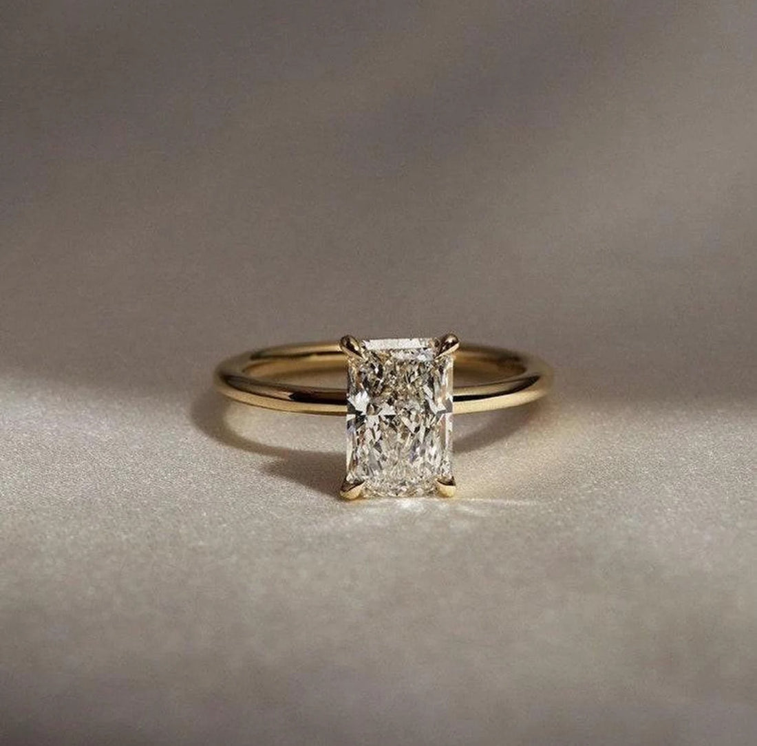 Elongated radiant cut lab grown diamond engagement ring with hidden halo in yellow gold