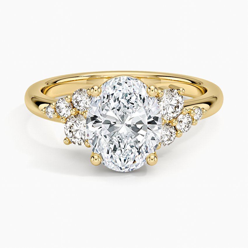 Oval cut lab grown diamond ring with graduated round clusters on a plain tapered band in yellow gold, top view