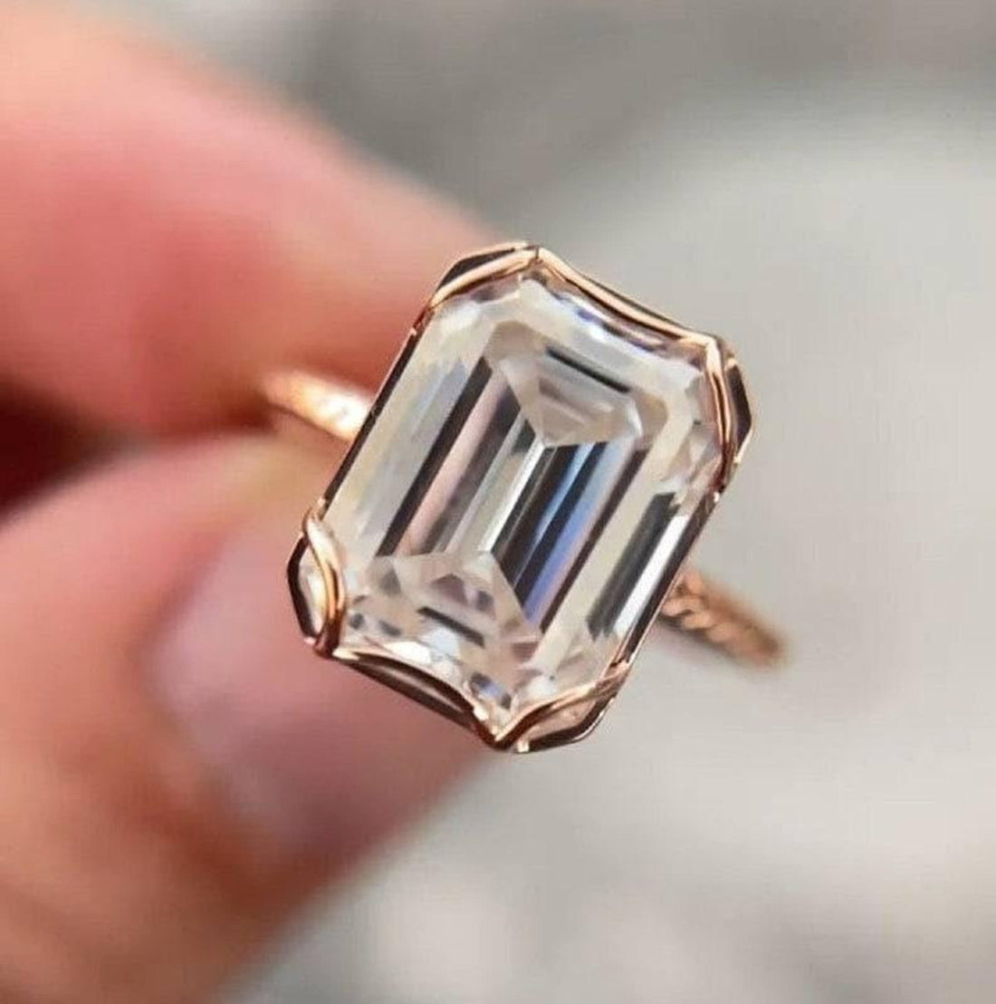 Emerald cut lab grown diamond bezel set ring in rose gold