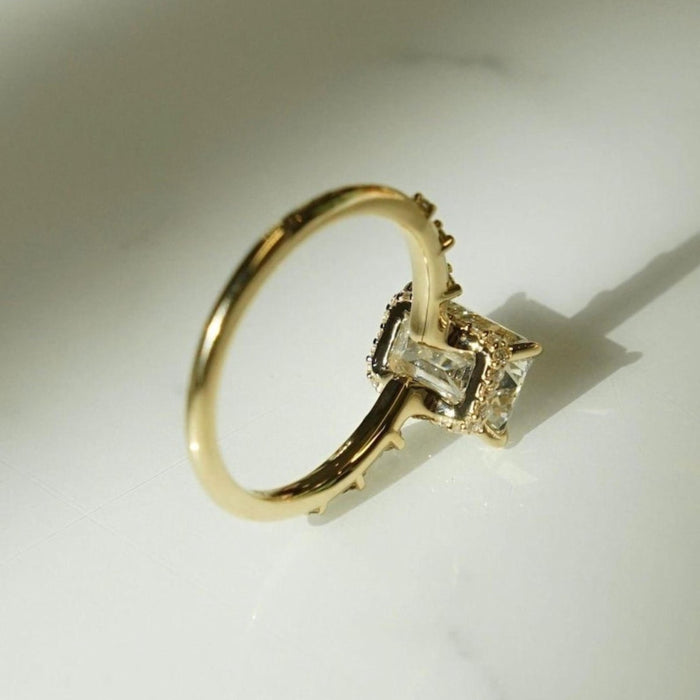 Emerald cut lab grown diamond engagement ring with hidden halo and distance pave band