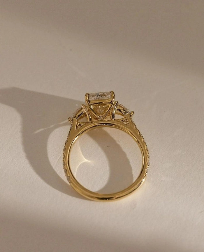 Radiant cut centre stone flanked by two pear cut side stones
