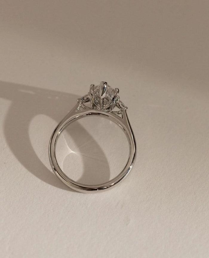 Profile of the marquise three stone ring with pear accents