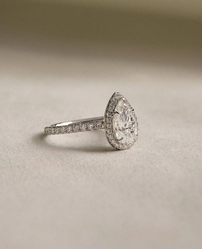 Pear cut lab grown diamond halo engagement ring with pave band, front view
