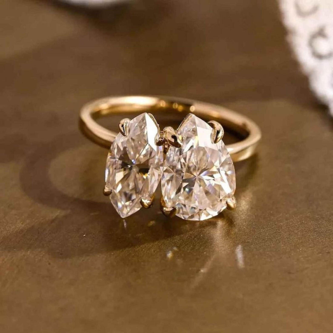 Toi et moi pear and marquise ring further view