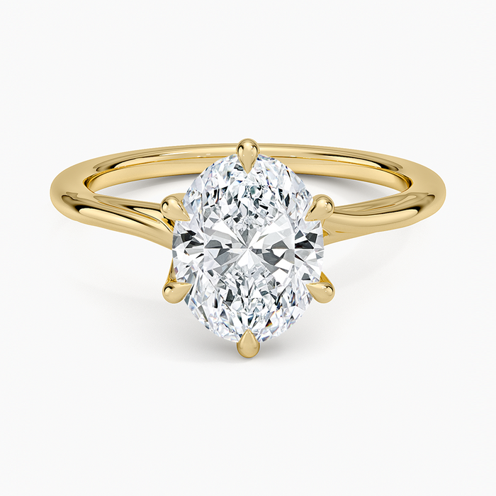 Oval cut lab grown diamond solitaire ring with six talon claws in yellow gold, top view