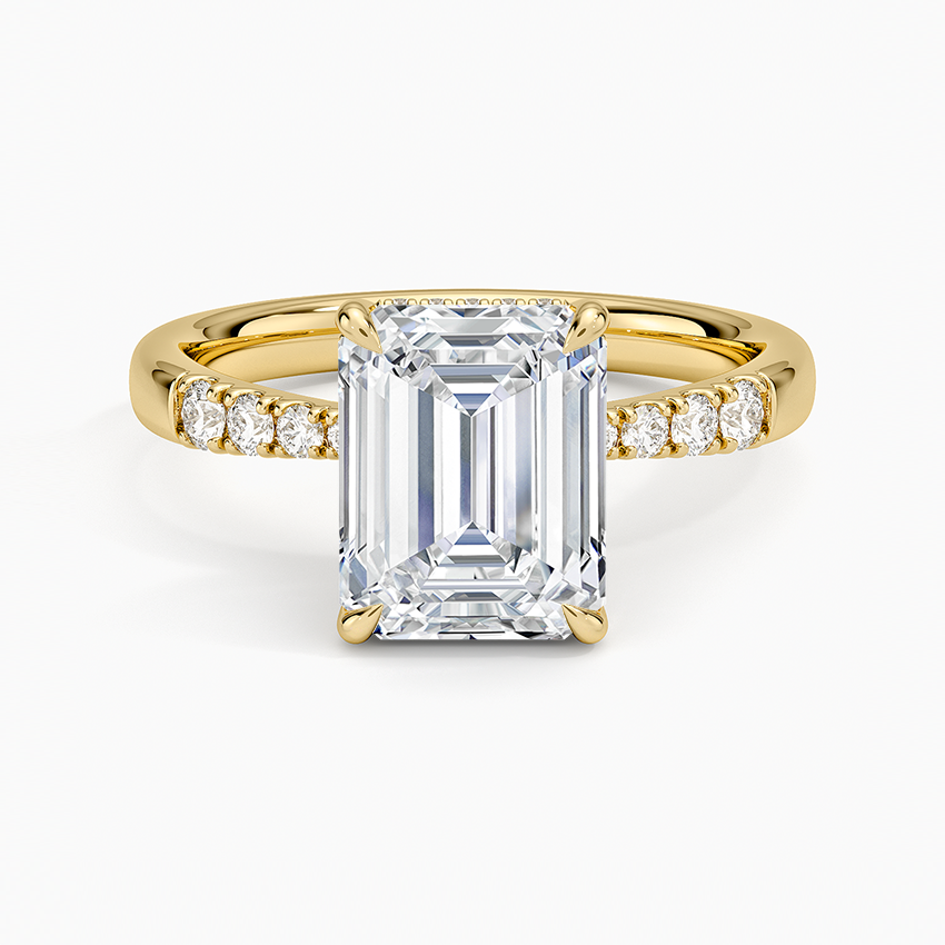 Emerald cut lab grown diamond ring in yellow gold with tapering pave shoulders, top view