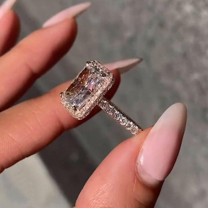 Full halo of round accents surrounding the radiant cut lab grown diamond