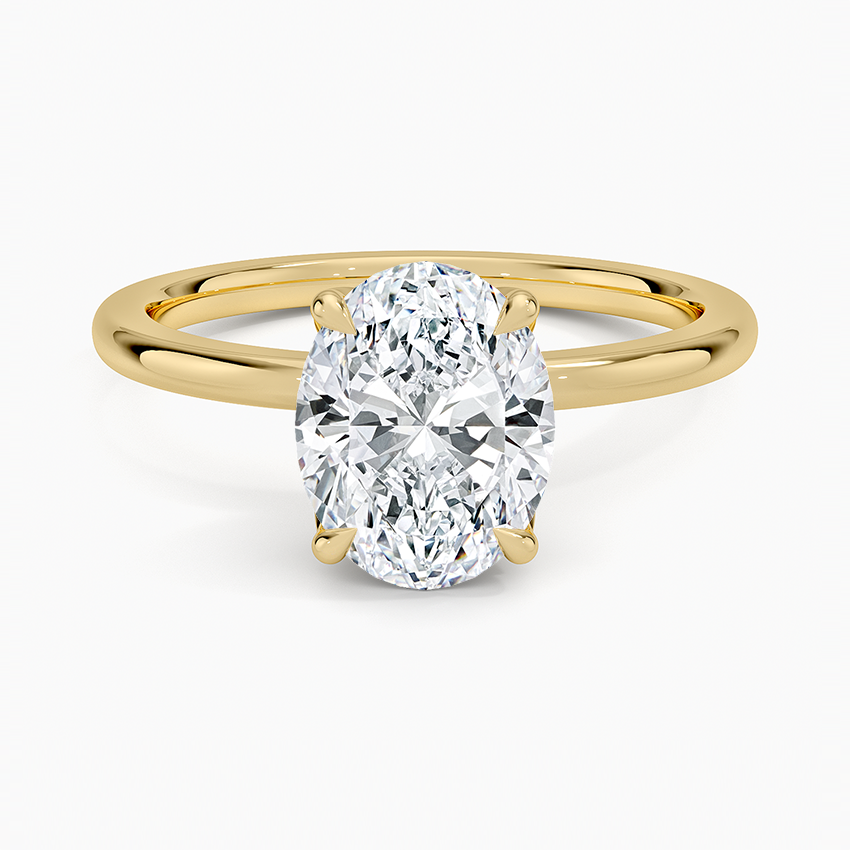 Oval cut lab grown diamond ring with a pave set lotus petal basket in yellow gold, top view