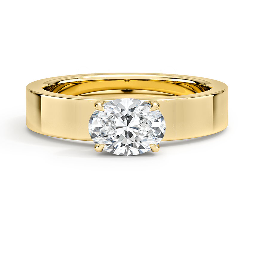 East west oval cut lab grown diamond ring set into a wide flat band in yellow gold, top view