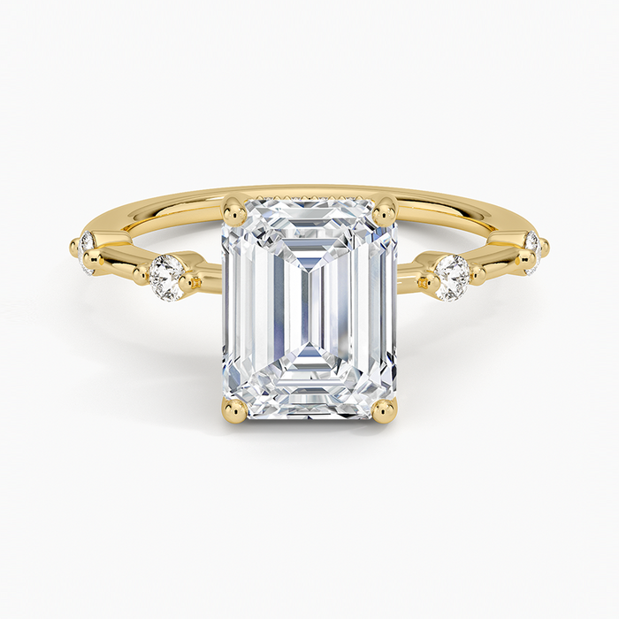 Emerald cut lab grown diamond ring in yellow gold with station set round accent diamonds, top view
