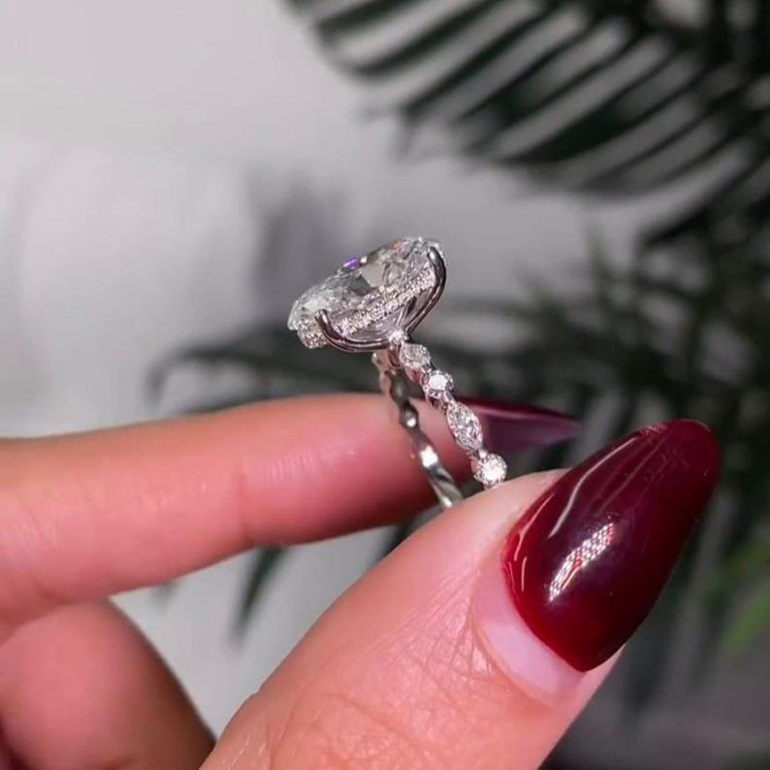 Oval cut lab grown diamond ring with marquise and round accents