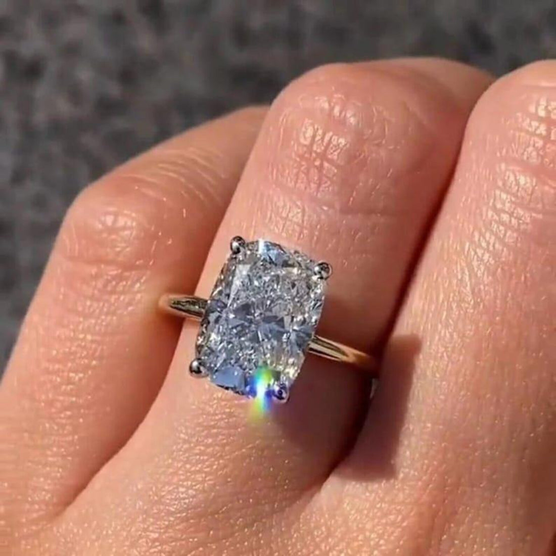 Elongated cushion cut lab grown diamond solitaire ring with hidden halo in yellow gold