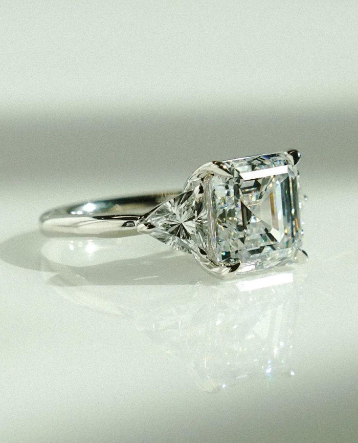 Asscher cut lab grown diamond three stone engagement ring with trillion side stones in white gold
