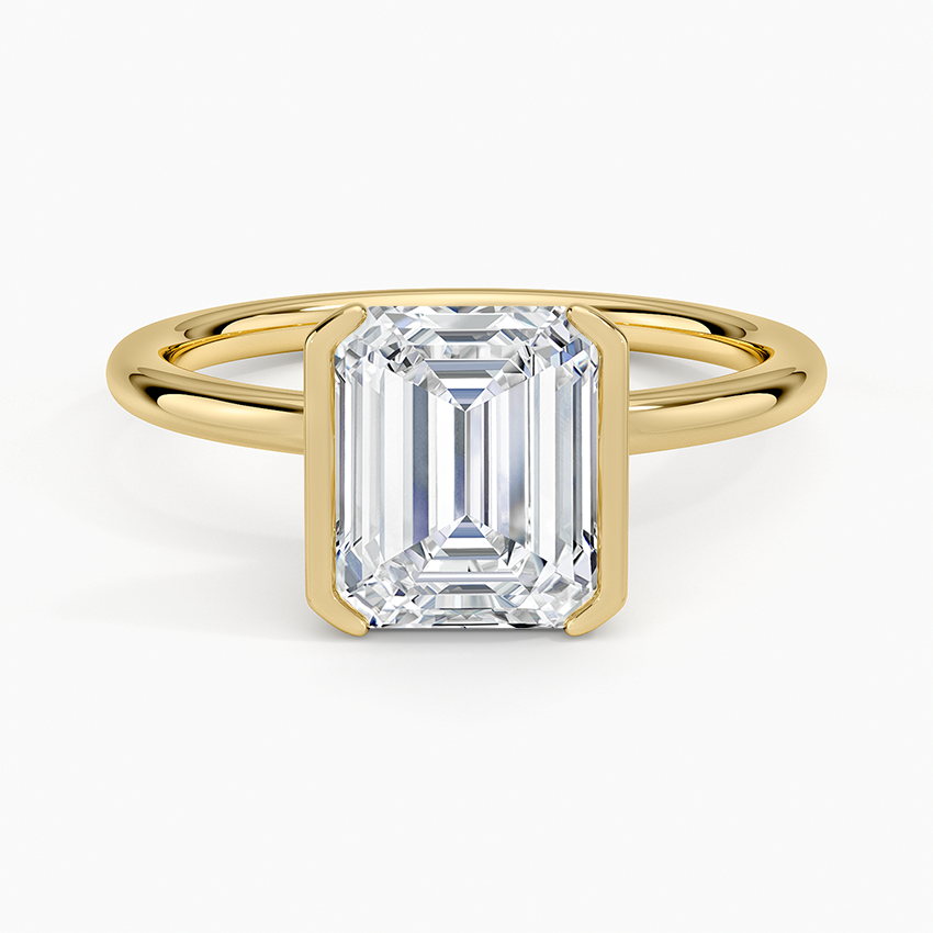 Emerald cut lab grown diamond ring in a yellow gold half bezel setting, top view