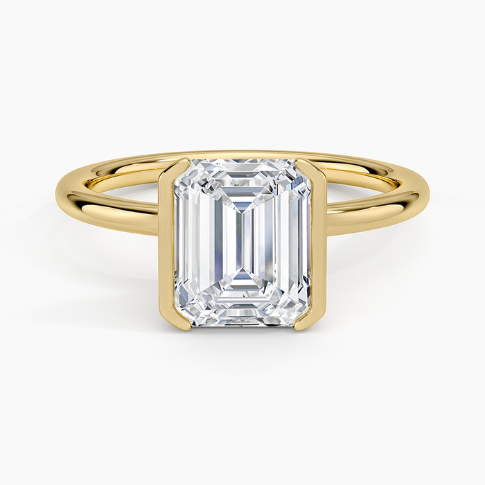 Emerald cut lab grown diamond ring in a yellow gold half bezel setting, top view