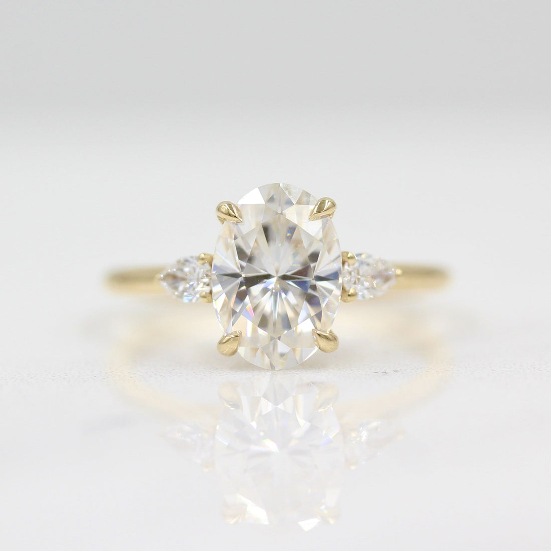 Oval and pear lab grown diamond three stone cathedral ring