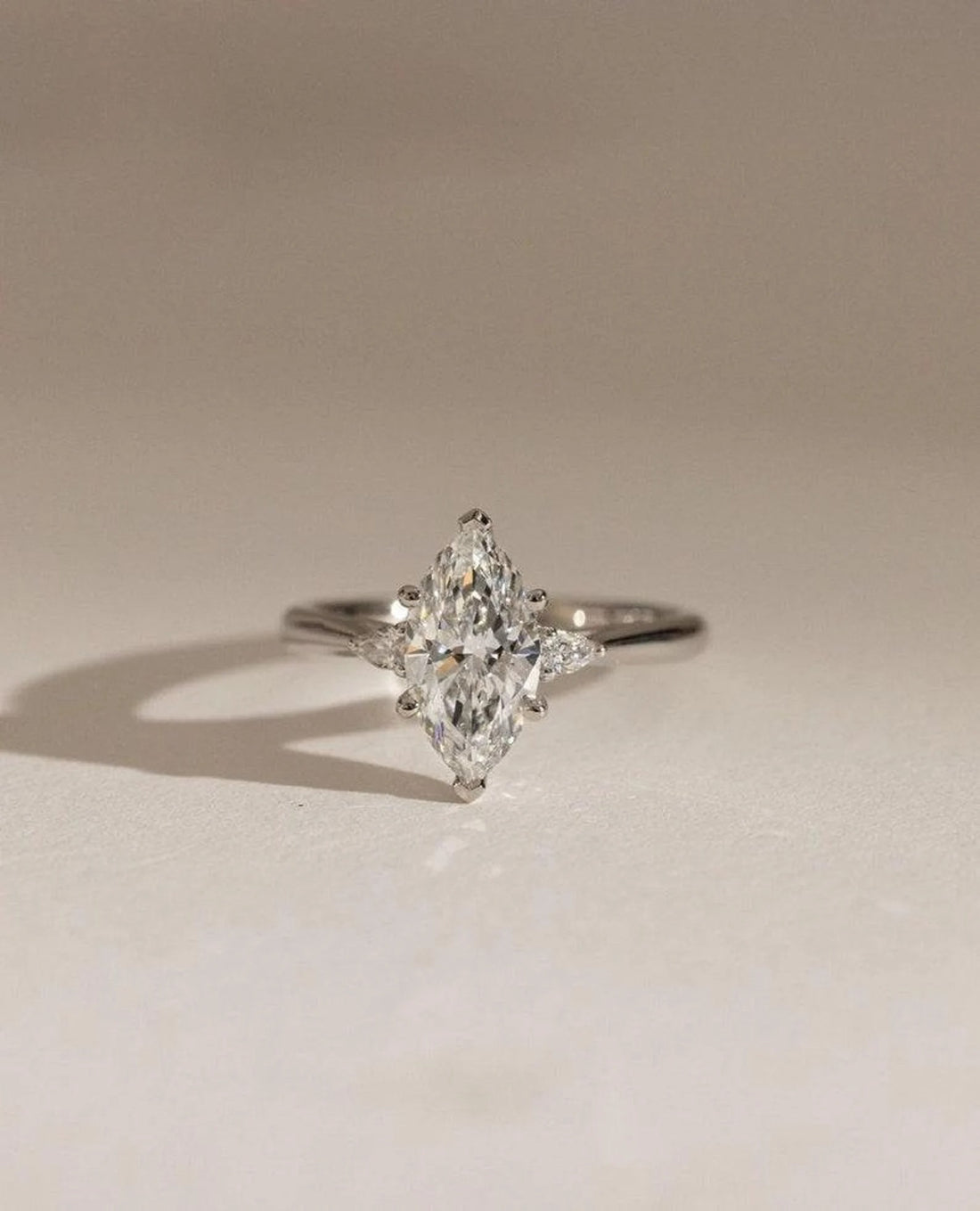 Three stone marquise cut lab grown diamond engagement ring with pear side stones in white gold