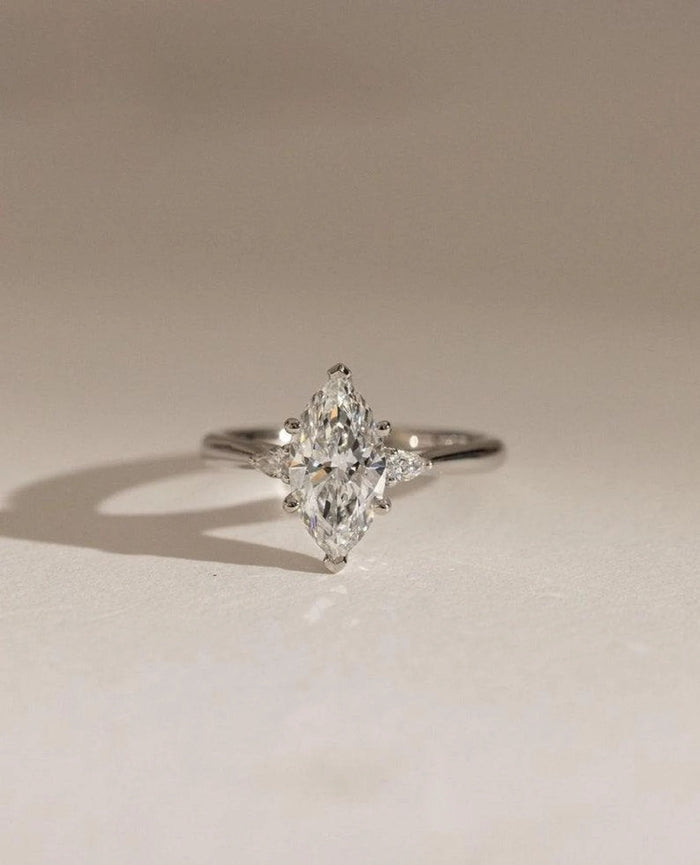 Three stone marquise cut lab grown diamond engagement ring with pear side stones in white gold