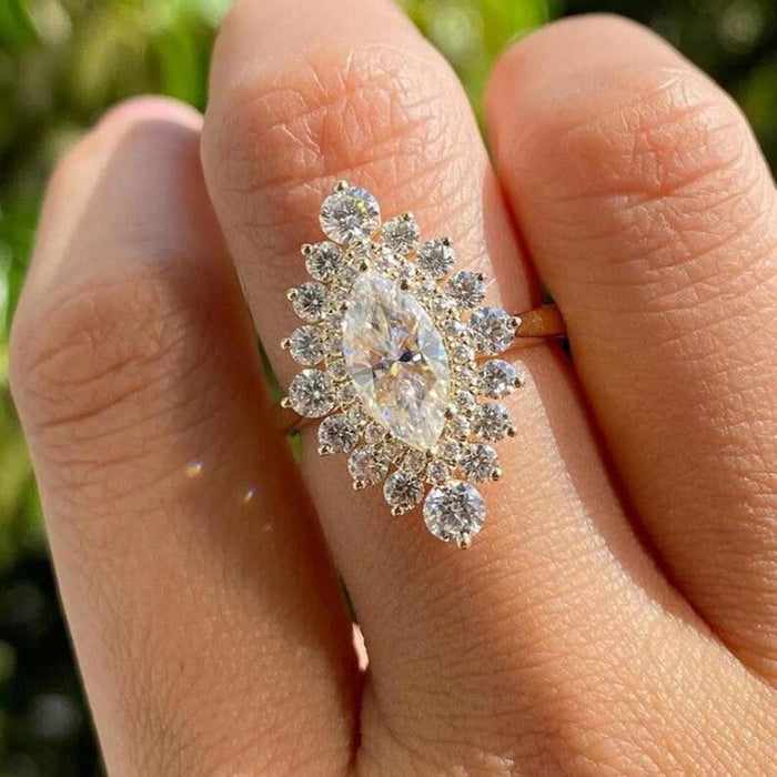 Graduated round accents radiating outward from the marquise centre stone