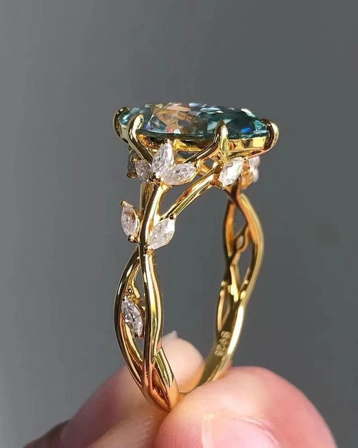 Teal moissanite vine and branch ring angled view