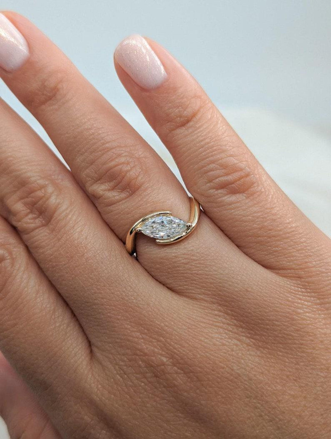 East west marquise cut lab grown diamond bypass ring with half bezel