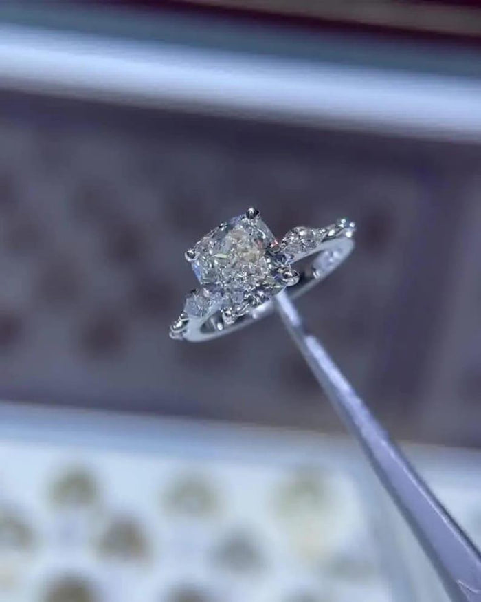 Cushion cut lab grown diamond engagement ring with marquise distance pave band