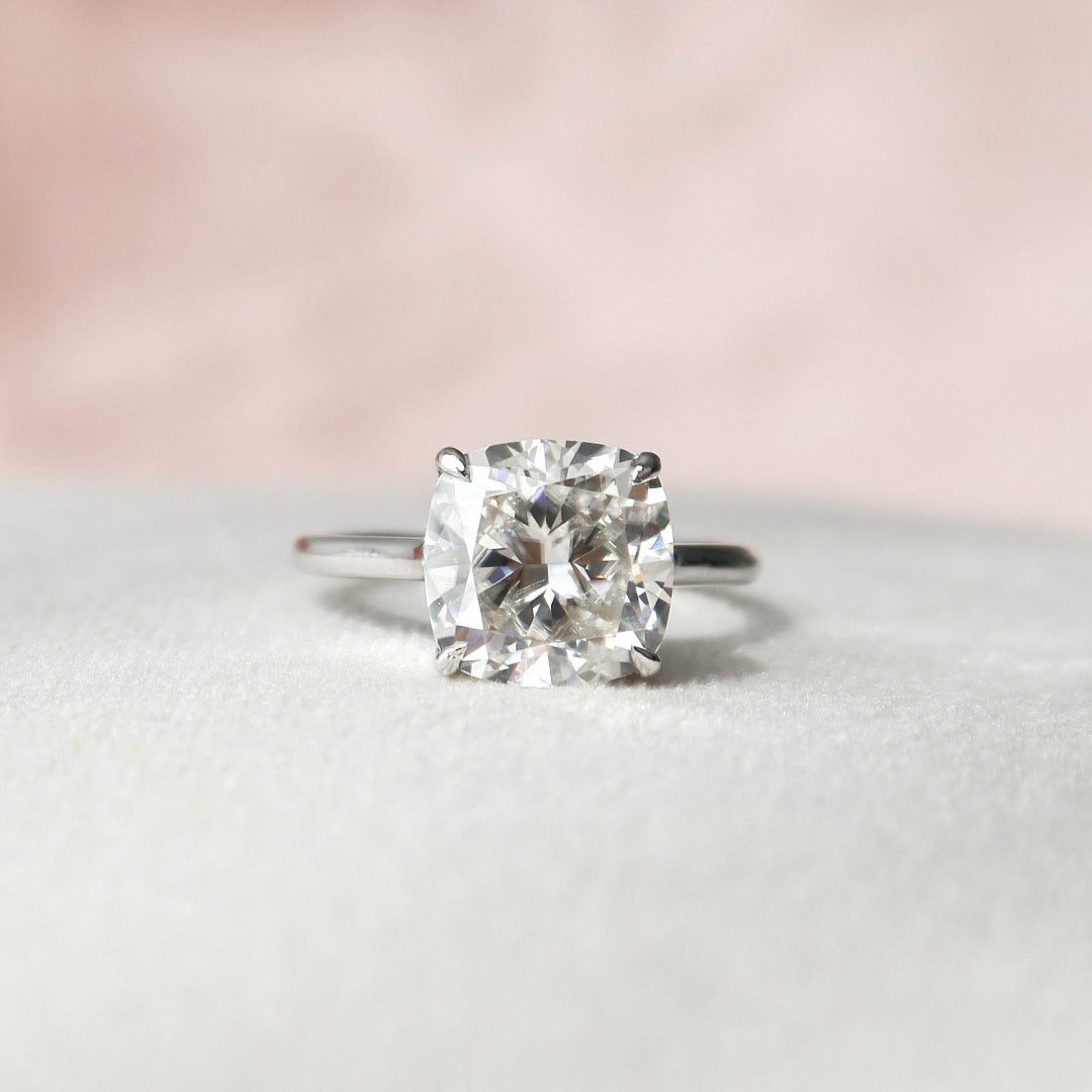 Cushion cut lab grown diamond ring with concealed halo on a cathedral shank